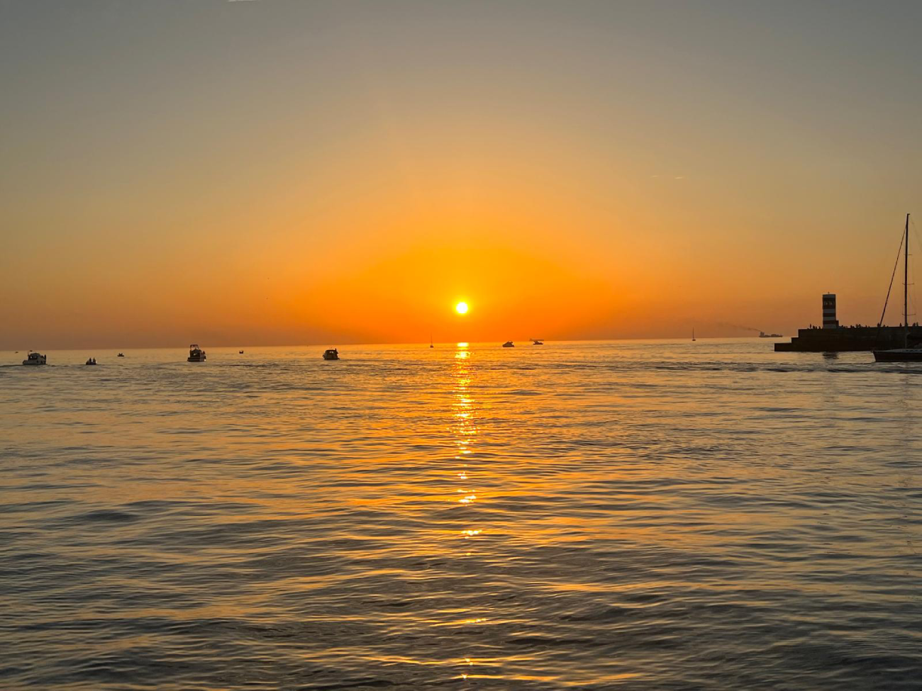 Captain at the helm at sunset