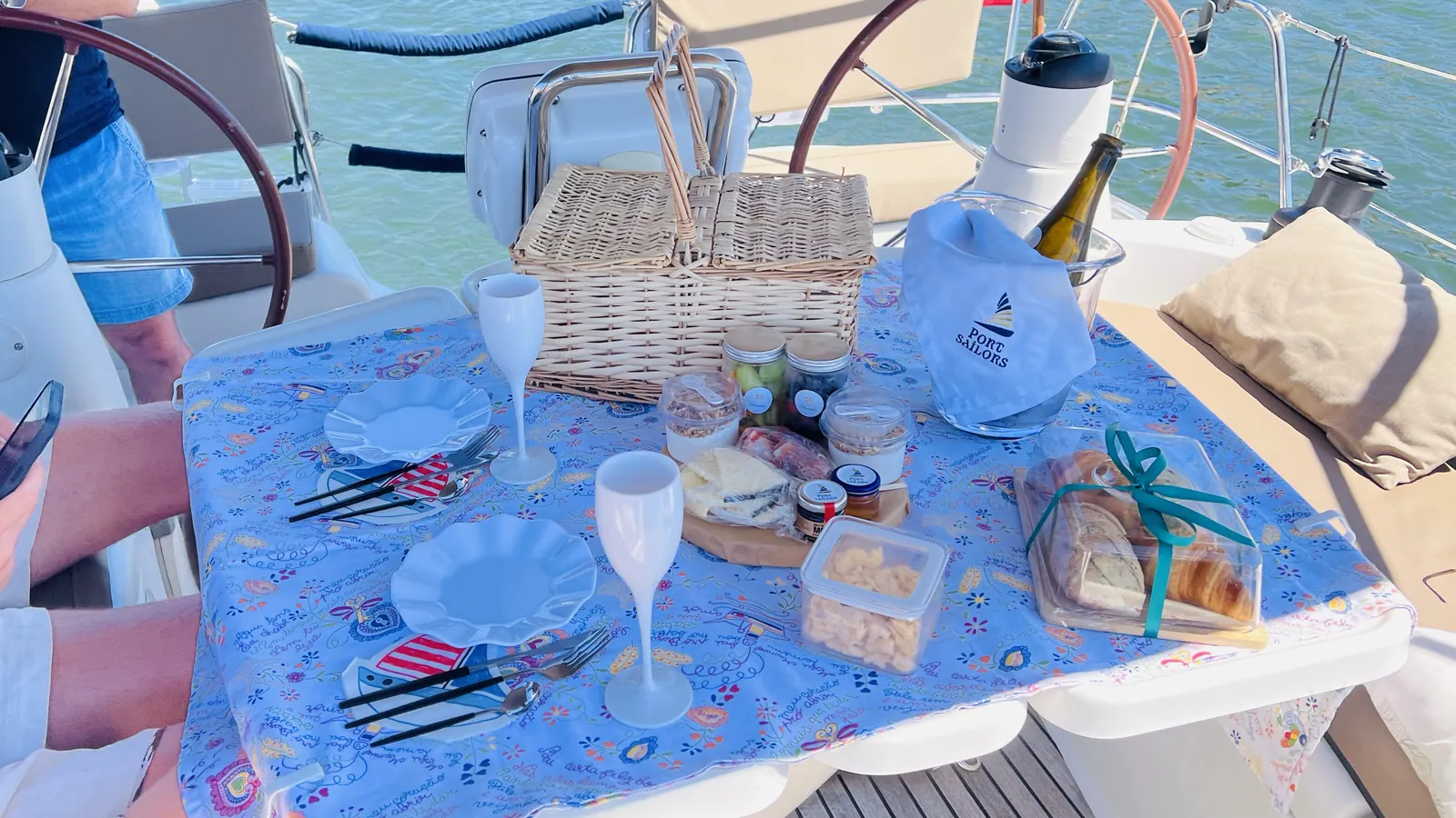 Picnic table with sparkling wine and Port Sailors napkin set for a Porto sailing celebration