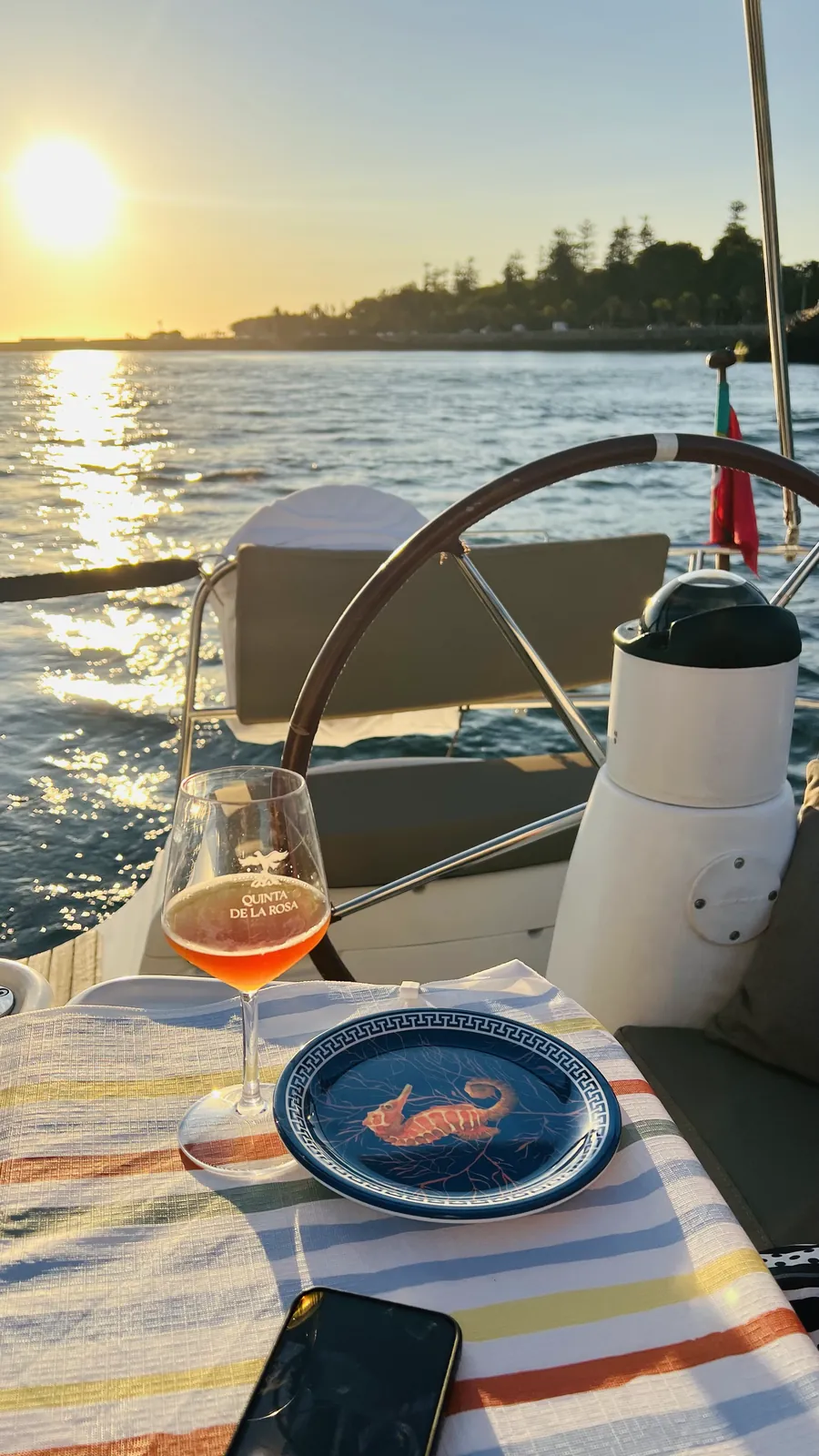 Glass of rose and tapas on deck as the sun sets over Foz do Douro
