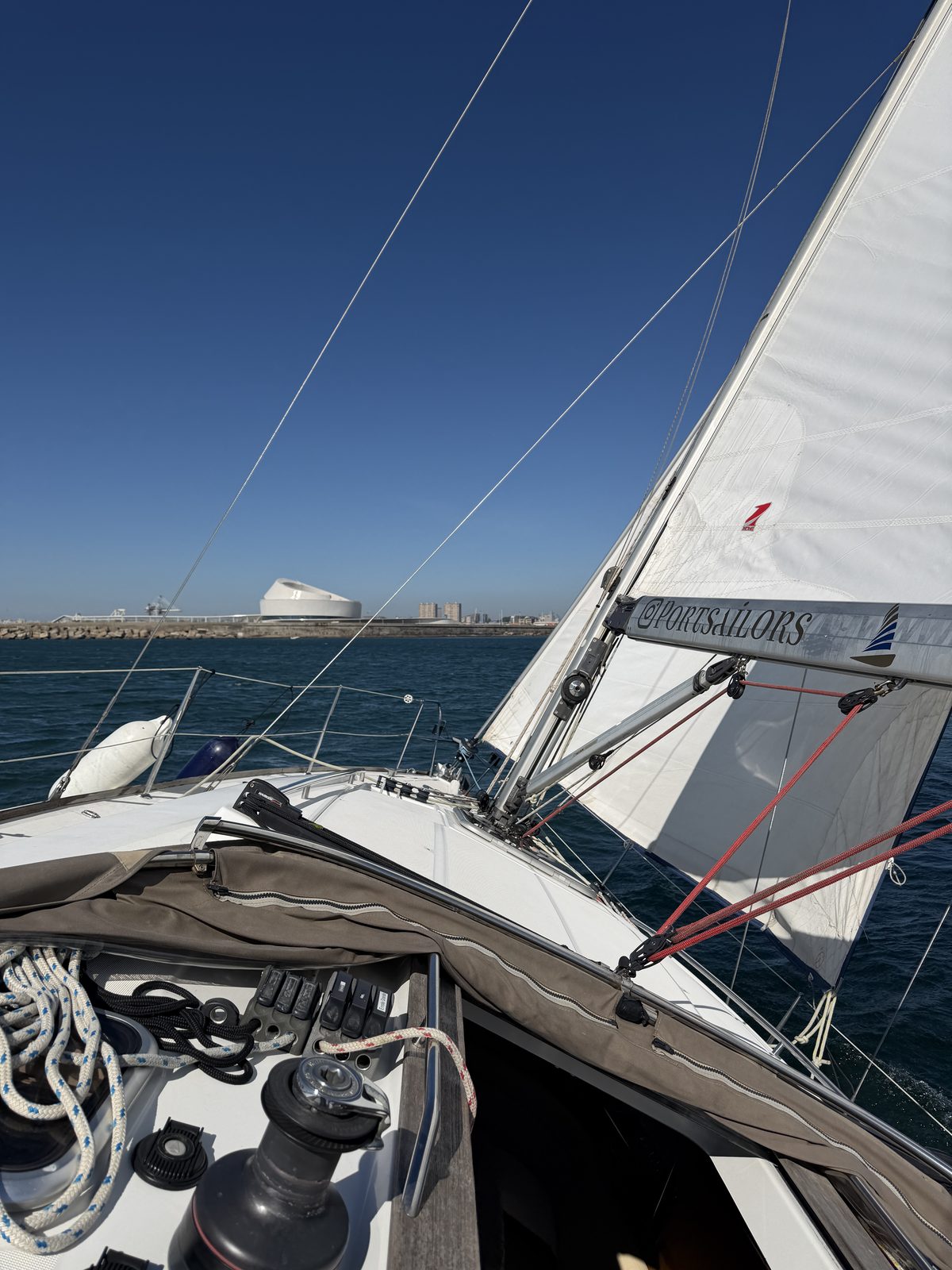 Guests in light layers on the deck of a Port Sailors sailboat on the Douro in autumn